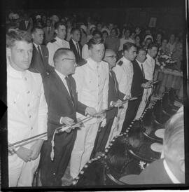 Fotografia "Benção de espadins na Candelária; 'ESCOLA NAVAL' 'CADETES' Benção de Espadins na Igreja da Candelária, entrega de espadim aos novos oficiais da Marinha, servindo de paraninfo do cadete, Mario Ubirajara Hoeke, o Sr. João Etcheverry)" ([Local n/d] , 1963) [negativo]. / Fotógrafo(a): Ferreira.  -- ITEM-0002.