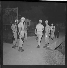 Fotografia "Blitz Policial na Favela do Esqueleto c/ [Duarte]; 'BATIDAS POLICIAIS' 'Blitz' Policial na Favela de Esqueleto, no Maracanã, Reportagem de Duarte" ([Local n/d] , 1963) [negativo]. / Fotógrafo(a): José Gomes; Gomes.  -- ITEM-0007.