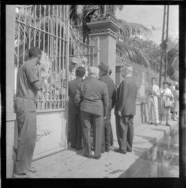 Fotografia "Helio Fernandes na P.E. (Chegada dos advogados, Prado Keli e Prudente de Morais Neto e o presidente do inquérito militar o Gal. Crisanto Figueiredo de Miranda" ([Local n/d] , 1963) [negativo]. / Fotógrafo(a): Rodolfo.  -- ITEM-0023.